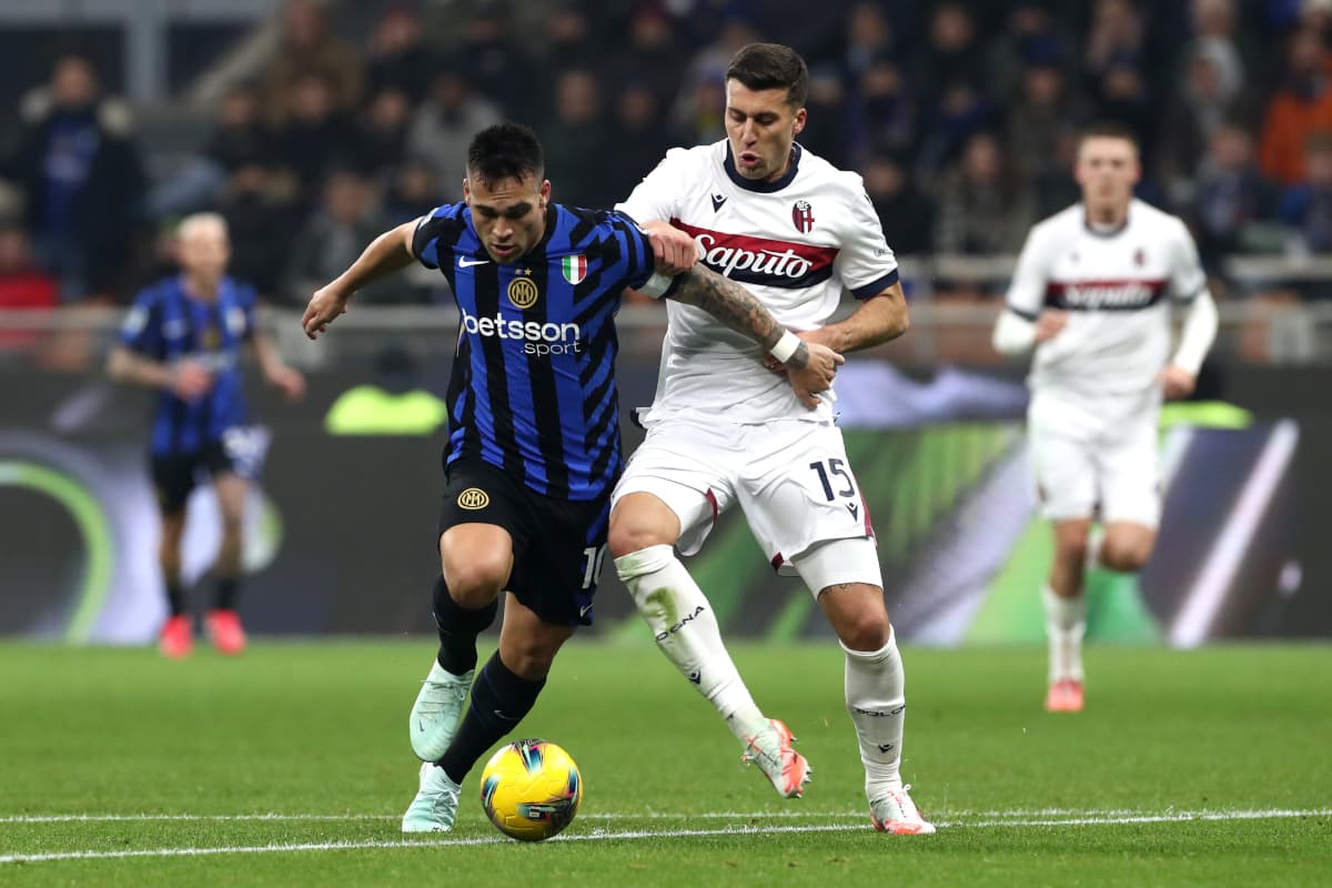 Inter player tackles Bologna opponent during match