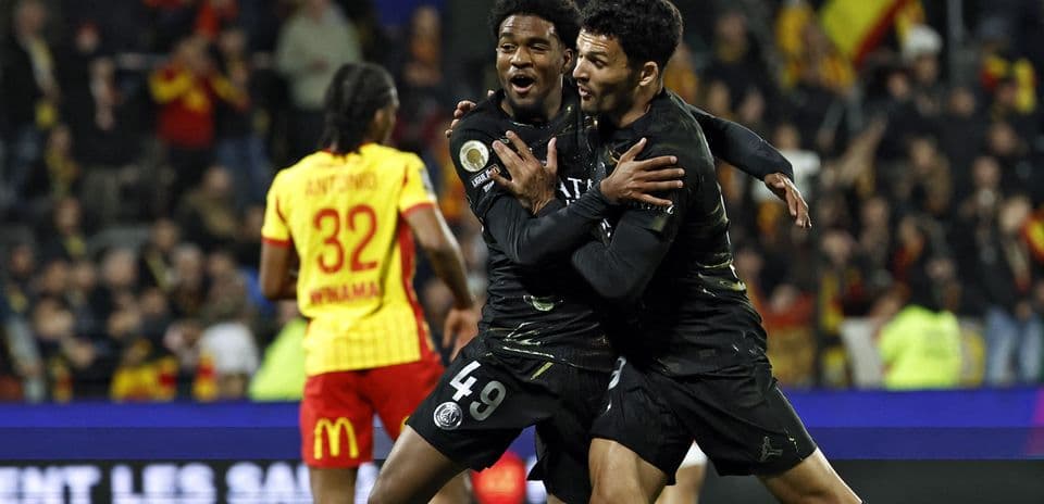 Two PSG players celebrating a goal on the field
