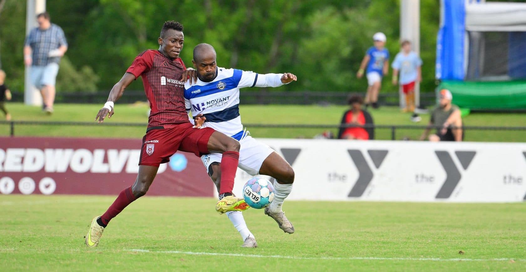 Players competing for the ball in USL match
