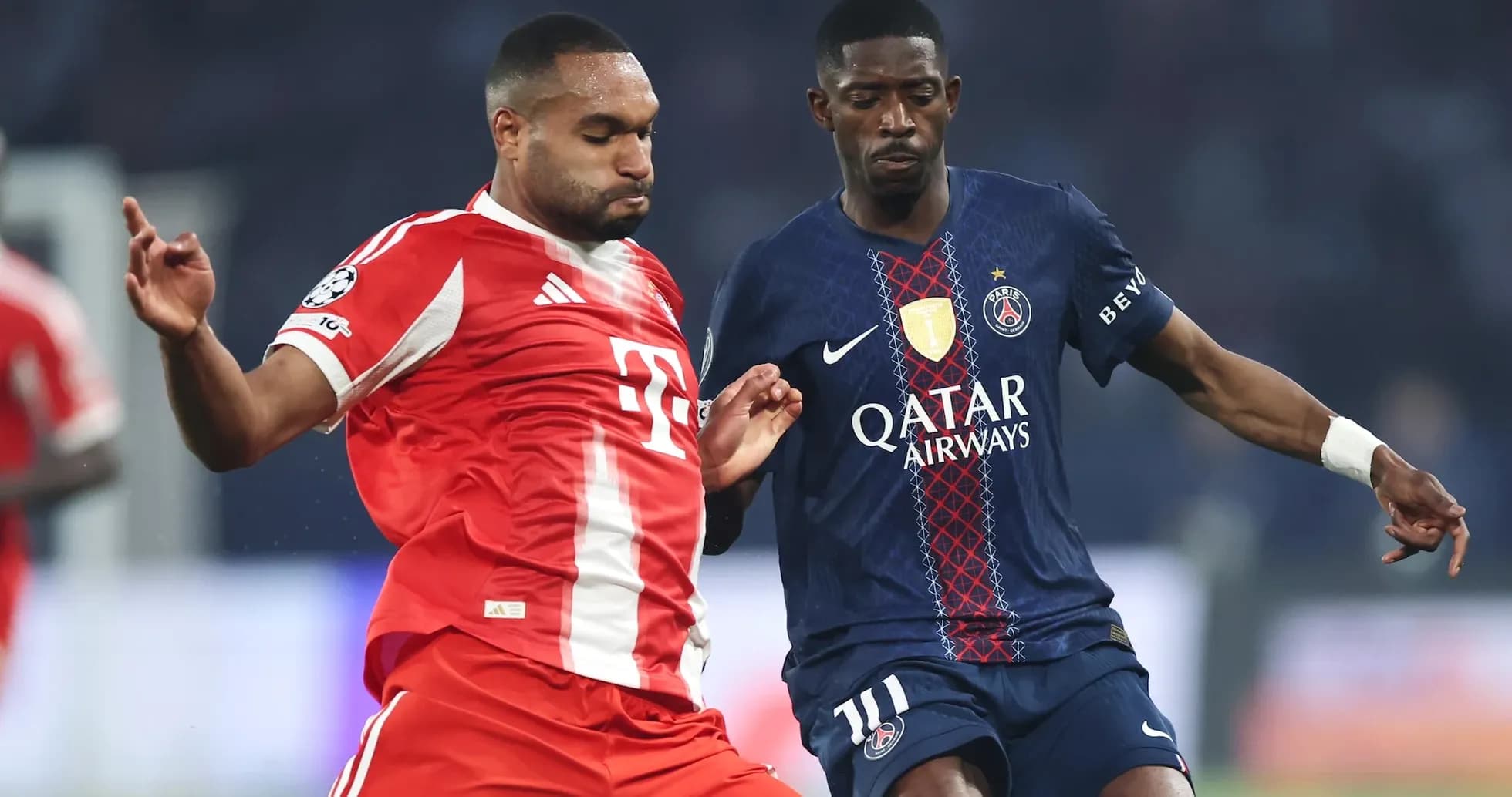 Two players competing for the ball in UEFA match