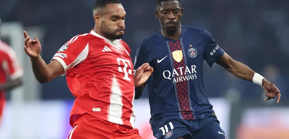 Two players competing for the ball in UEFA match