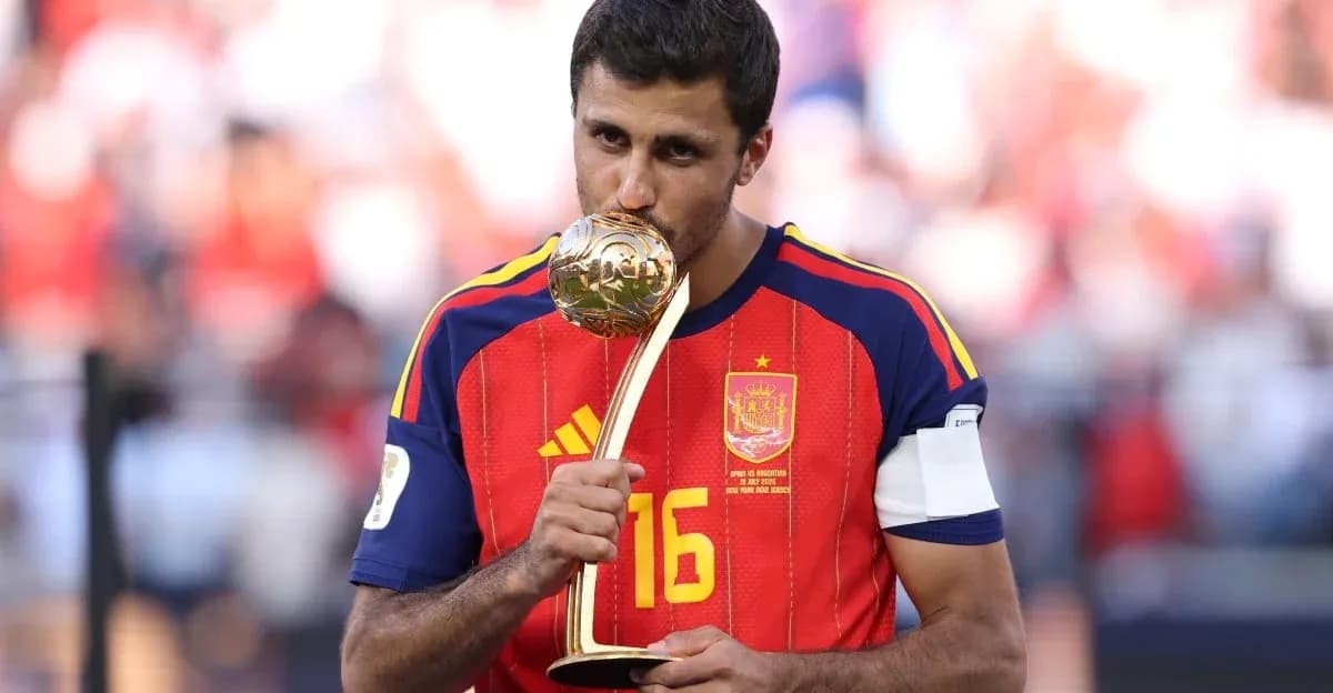 Player in Spain jersey holding a trophy