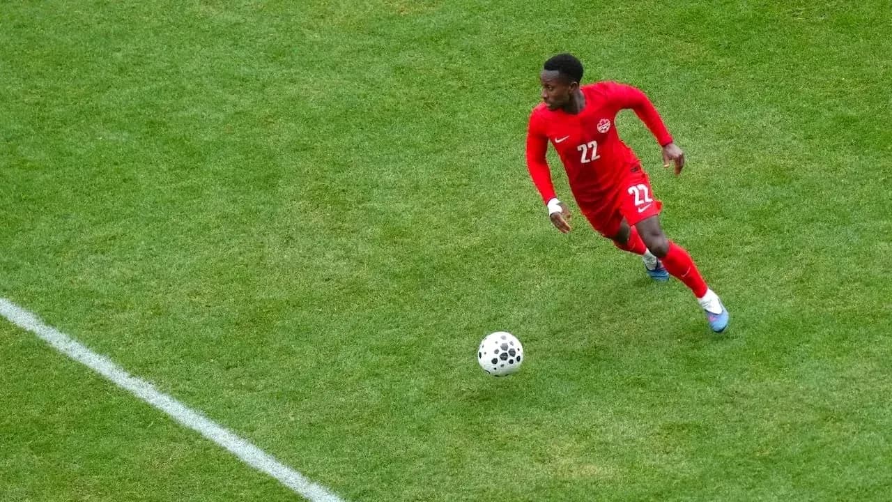 Player in red jersey running with the ball