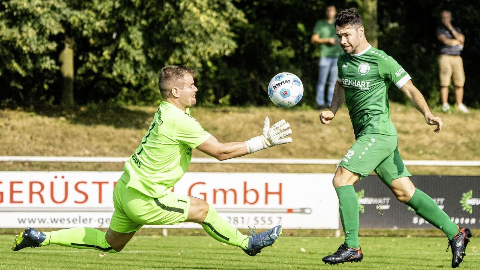 Goalkeeper attempting to catch the ball during match
