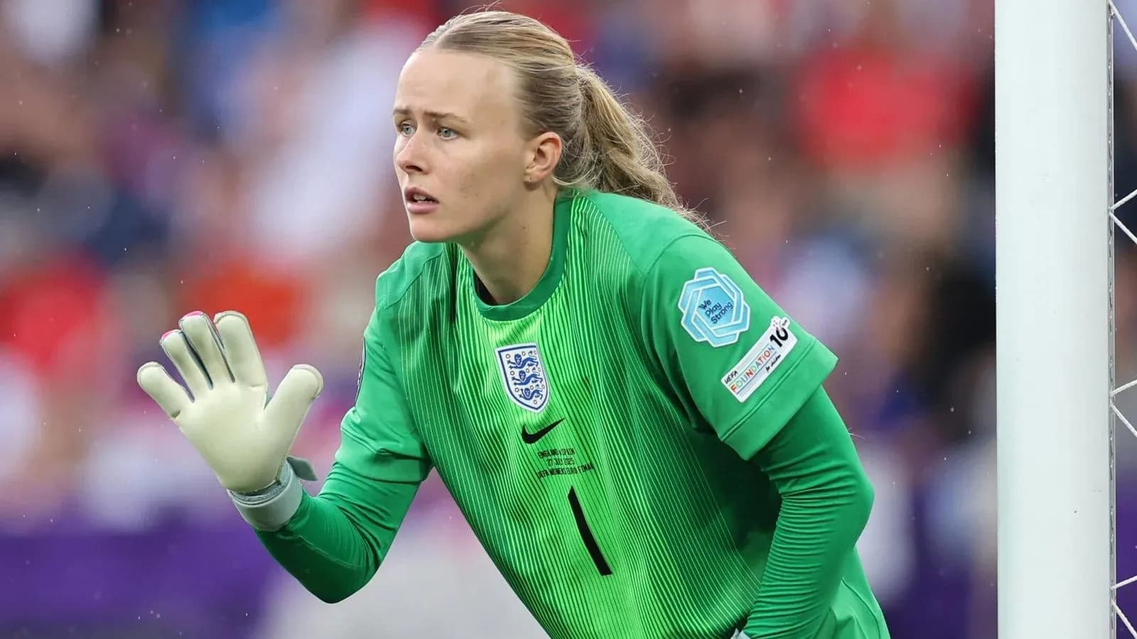 Goalkeeper in green kit gesturing during match