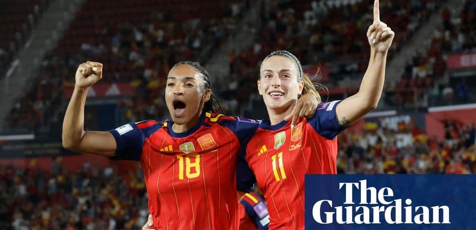 Two Spain players celebrating a goal during match