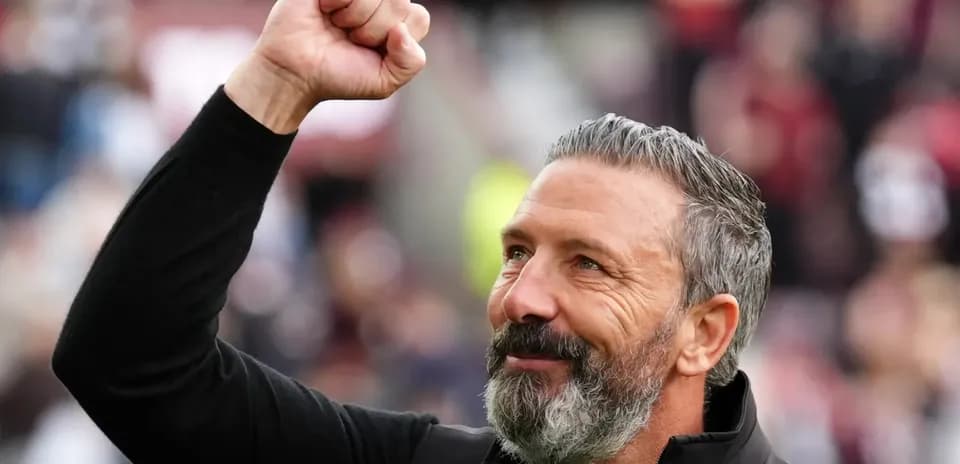 Coach celebrating with a raised fist in crowd