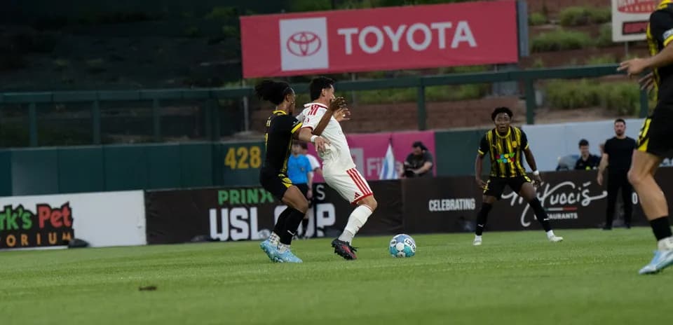 Players competing for the ball in USL match
