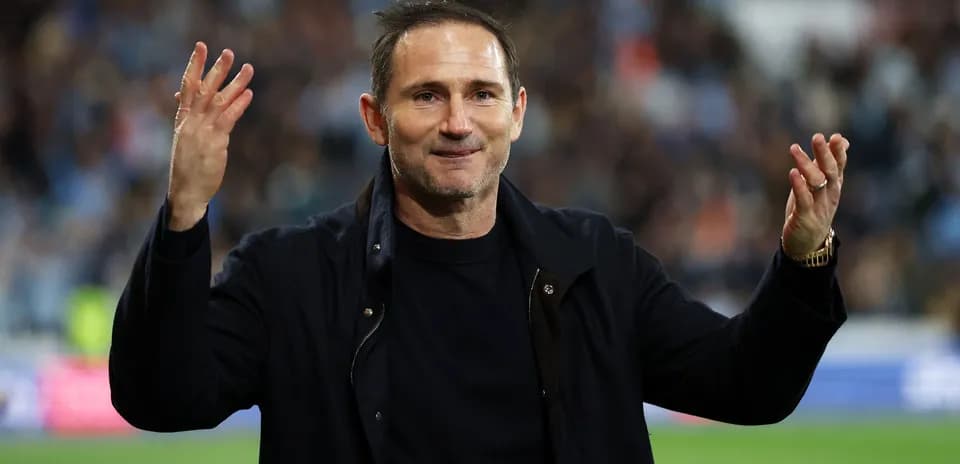 Coach gesturing to fans during a match