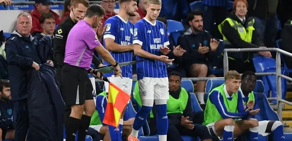 Substitutes preparing to enter the match on sidelines