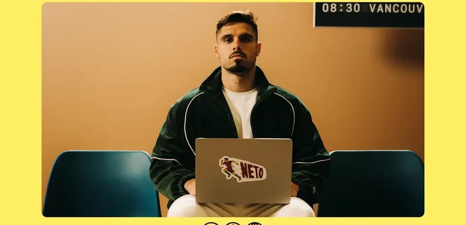 Person seated with laptop in waiting area