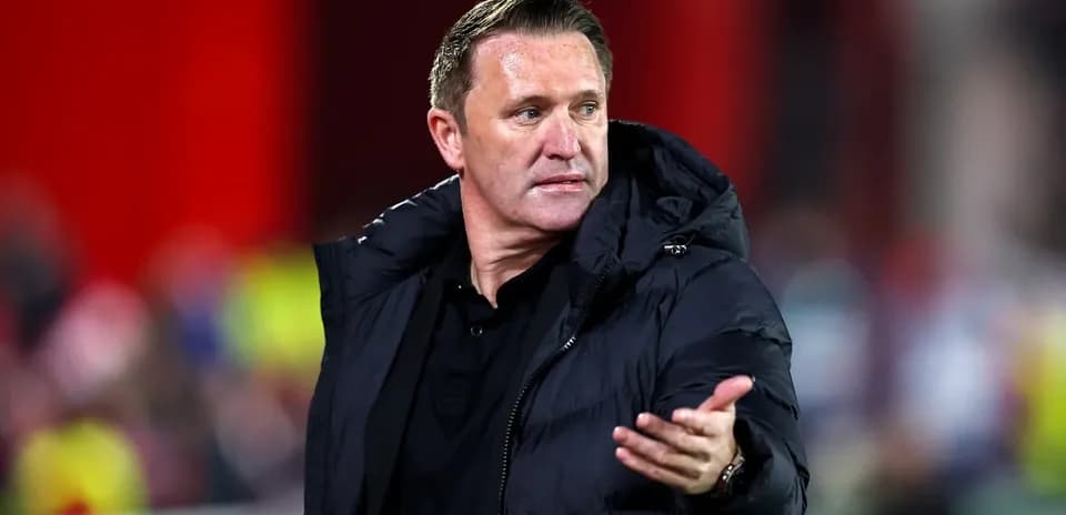 Manager gesturing during a match on the sideline