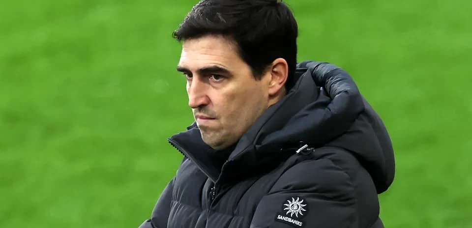 Coach observing the match with focused expression