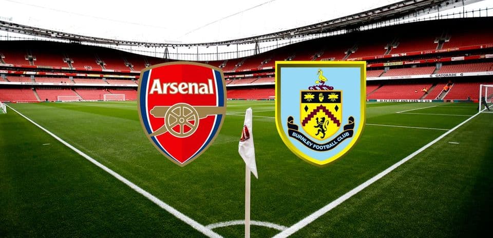 Arsenal and Burnley club logos on stadium pitch
