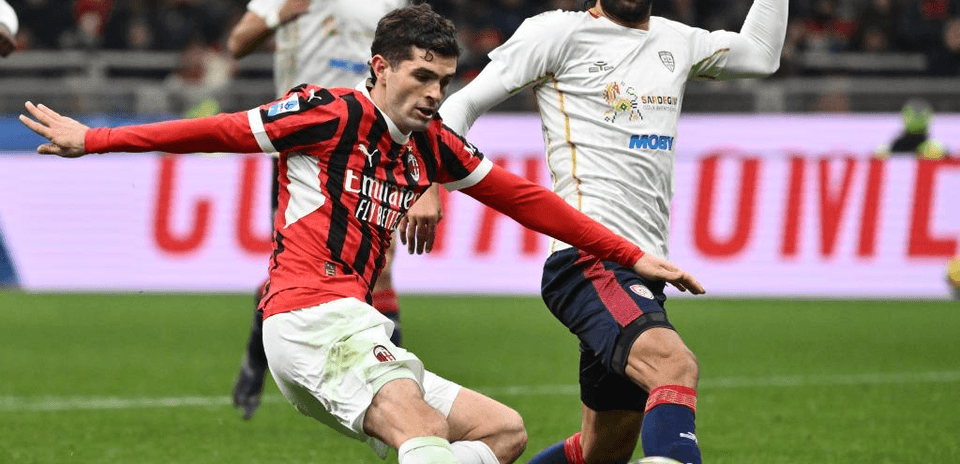 AC Milan player challenged by Cagliari opponent
