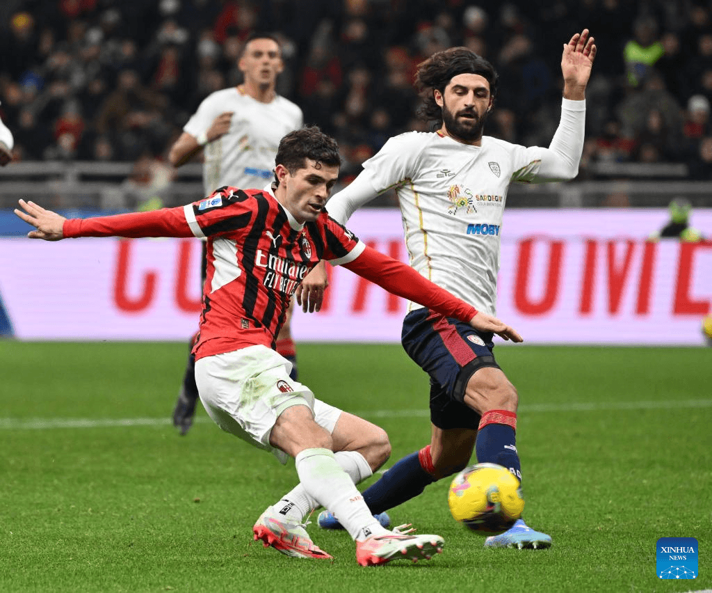AC Milan player challenged by Cagliari opponent AC Milan player challenged by Cagliari opponent