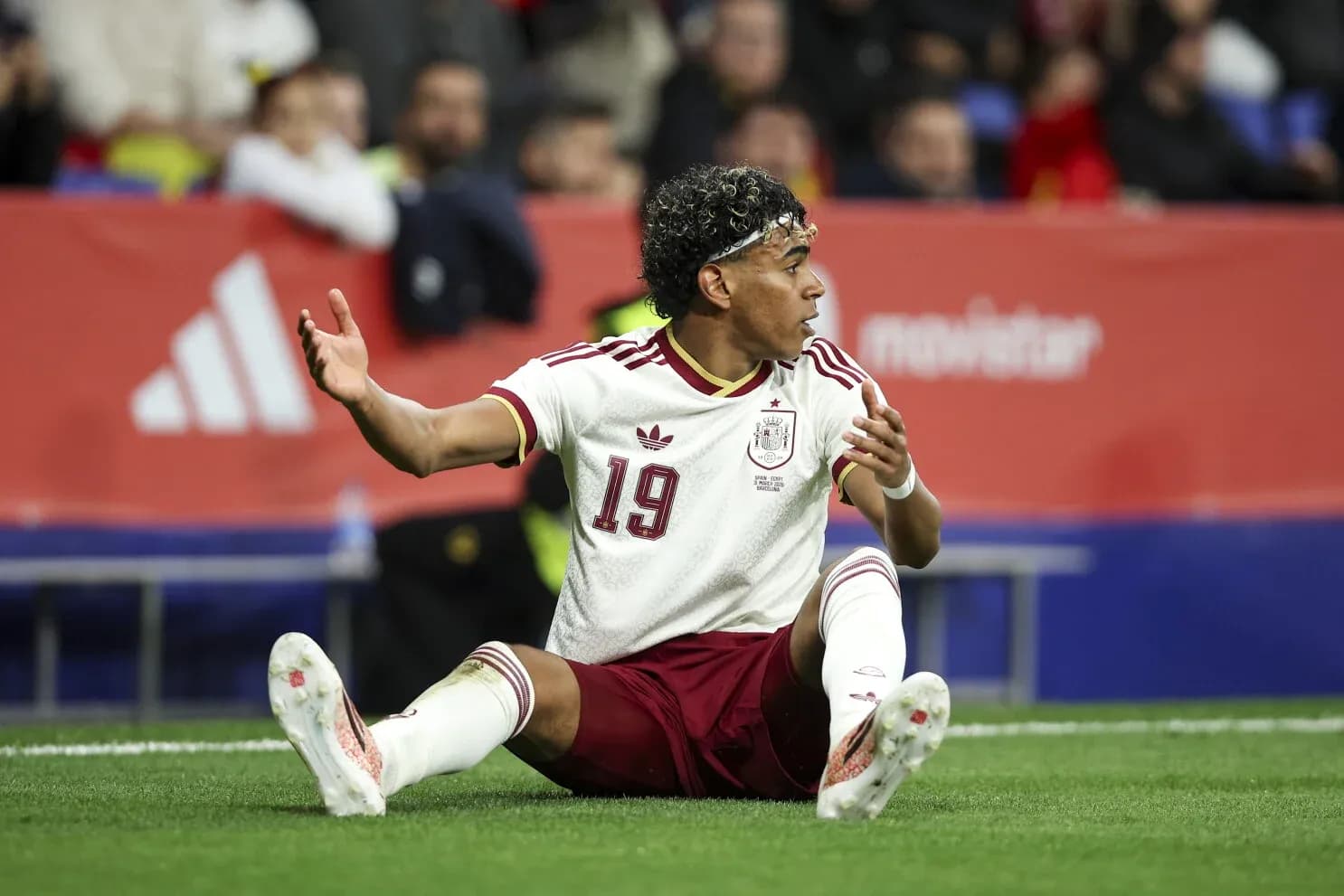 Spain player sitting on the field during match