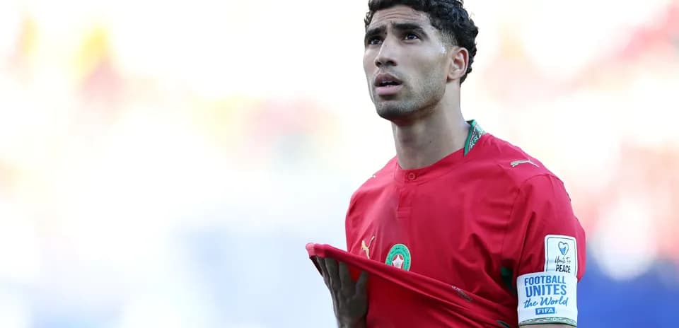 Player adjusting shirt during match in red uniform