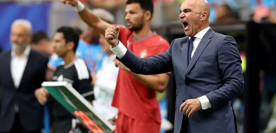 Coach celebrating and directing players during match
