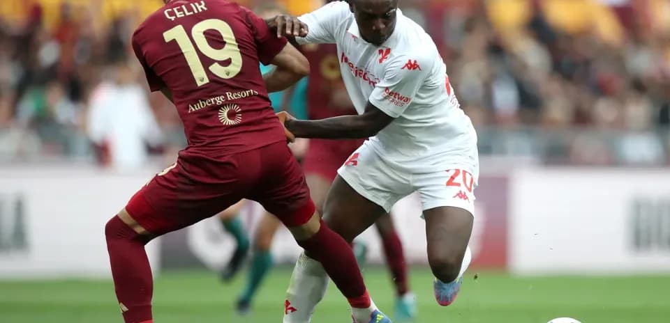 Celik and opponent battling for possession of the ball
