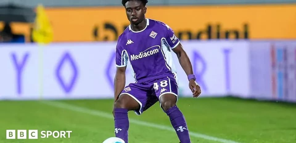 Player in purple jersey controlling the ball on field