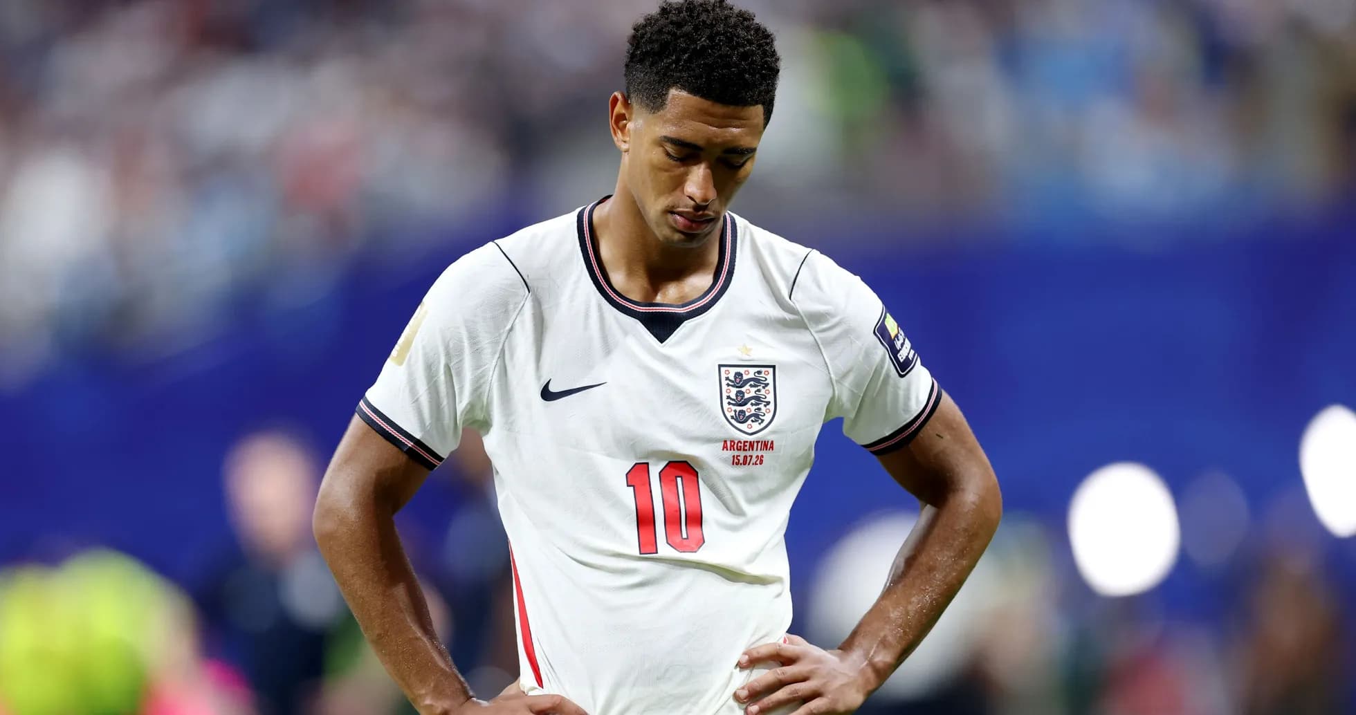 Player in England jersey looking down on the pitch