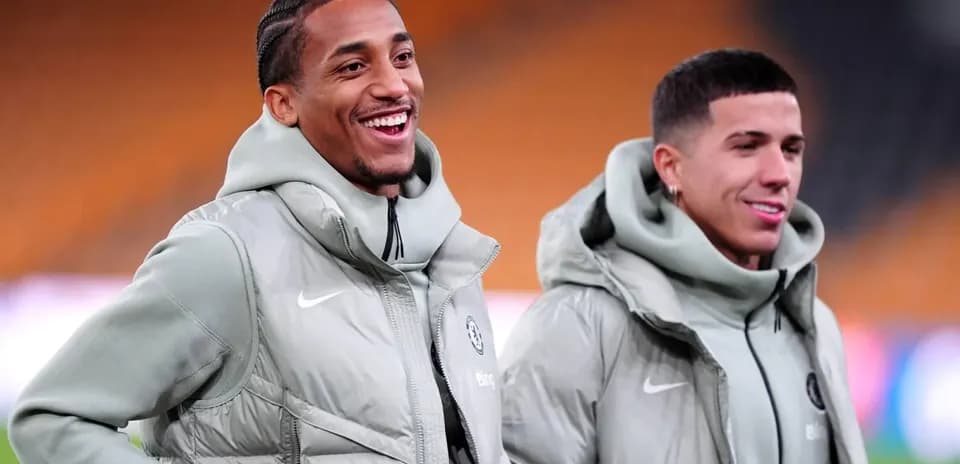 Two players smiling in matching team jackets