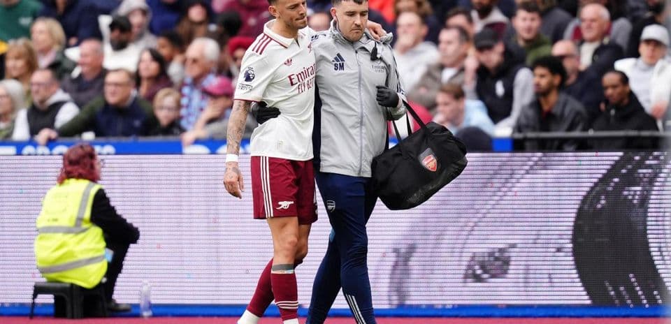 Player receiving assistance from medical staff on field