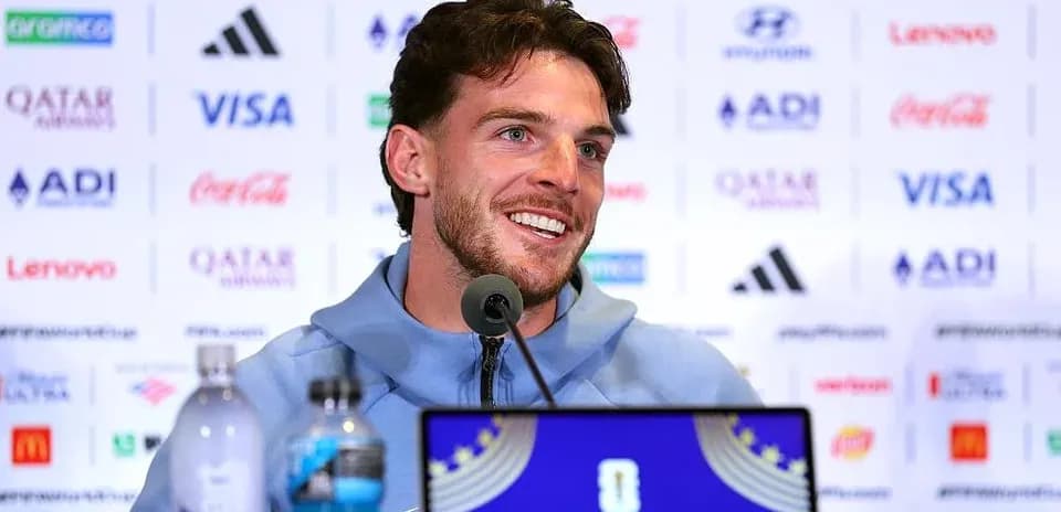 Player speaking at press conference with sponsor banners