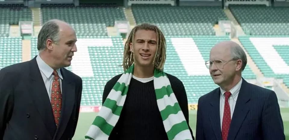 New player holding scarf during signing announcement