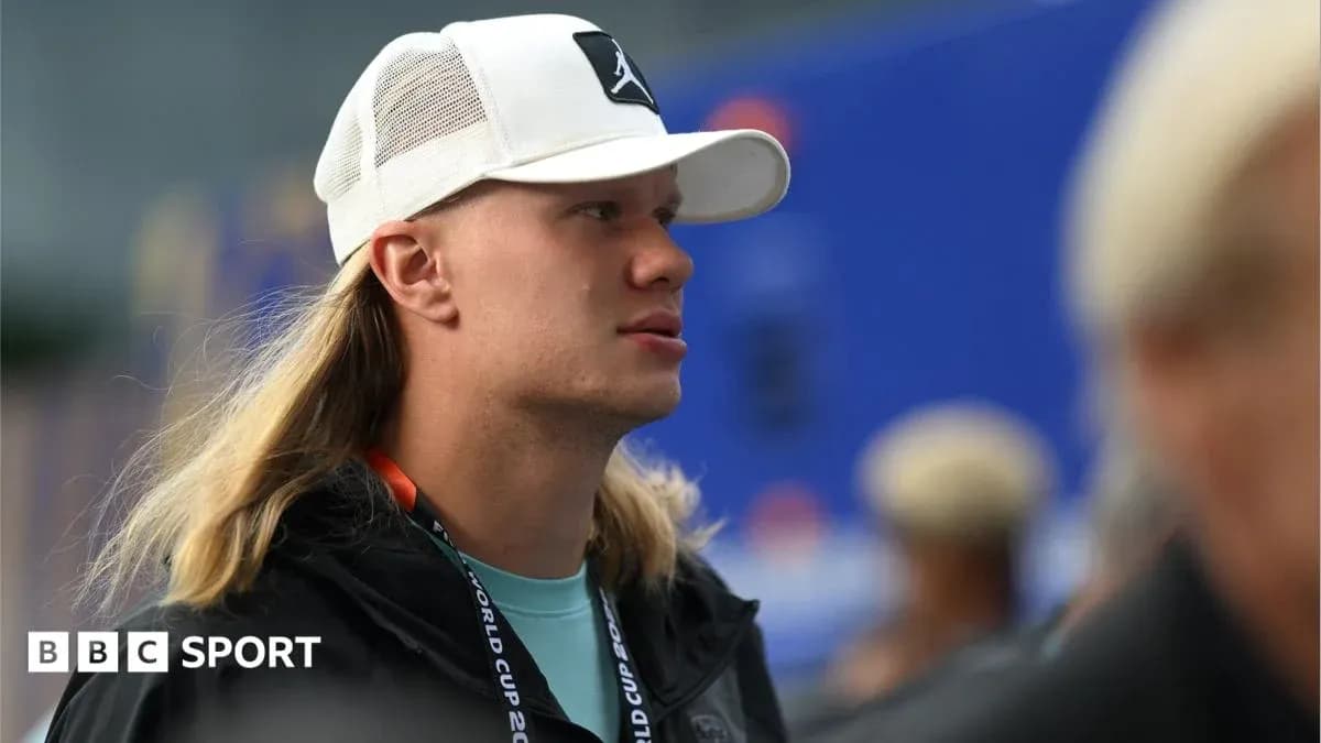 Individual with long hair wearing a white cap