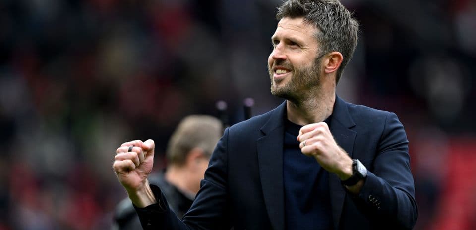 Coach celebrating with clenched fist on the field