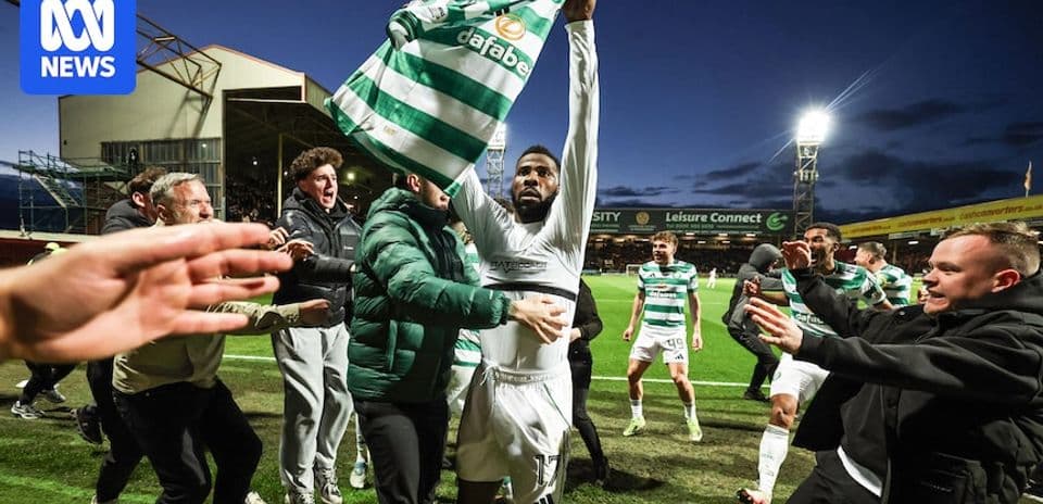 Player celebrating with fans after scoring a goal