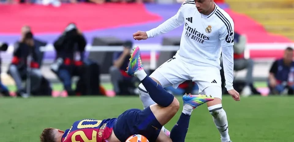Player from Barcelona falls during match against Real Madrid