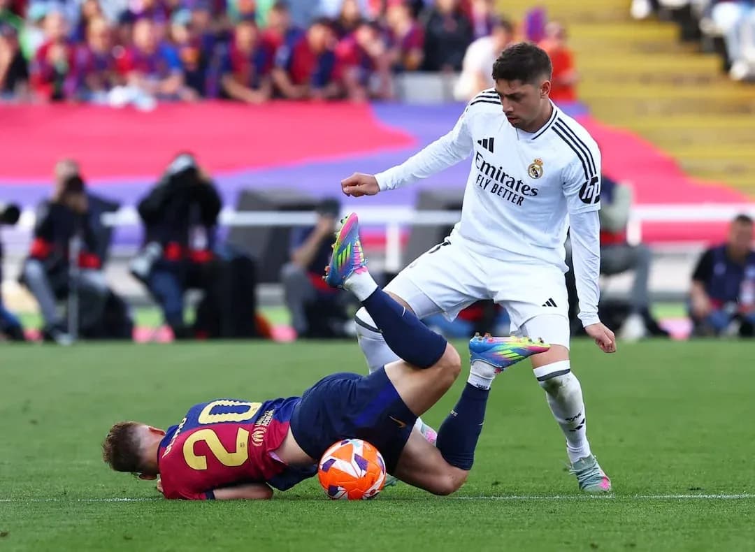 Player from Barcelona falls during match against Real Madrid