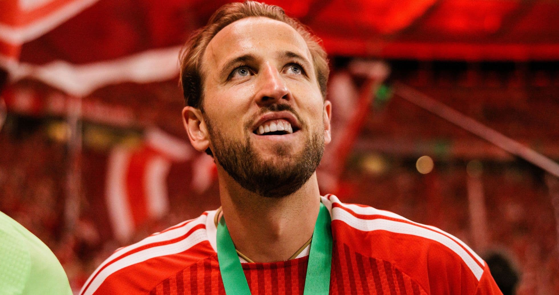 Player celebrating with medal in stadium atmosphere