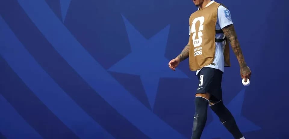 Player walking on the pitch in training bib