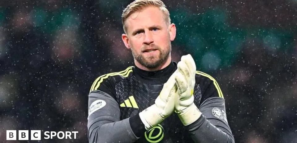 Goalkeeper clapping in snowy conditions during match