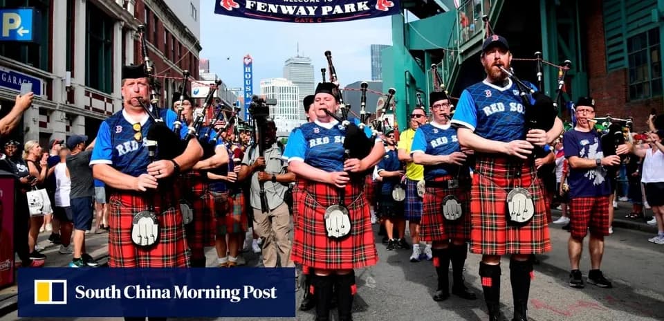 Bagpipers in kilts marching near Fenway Park