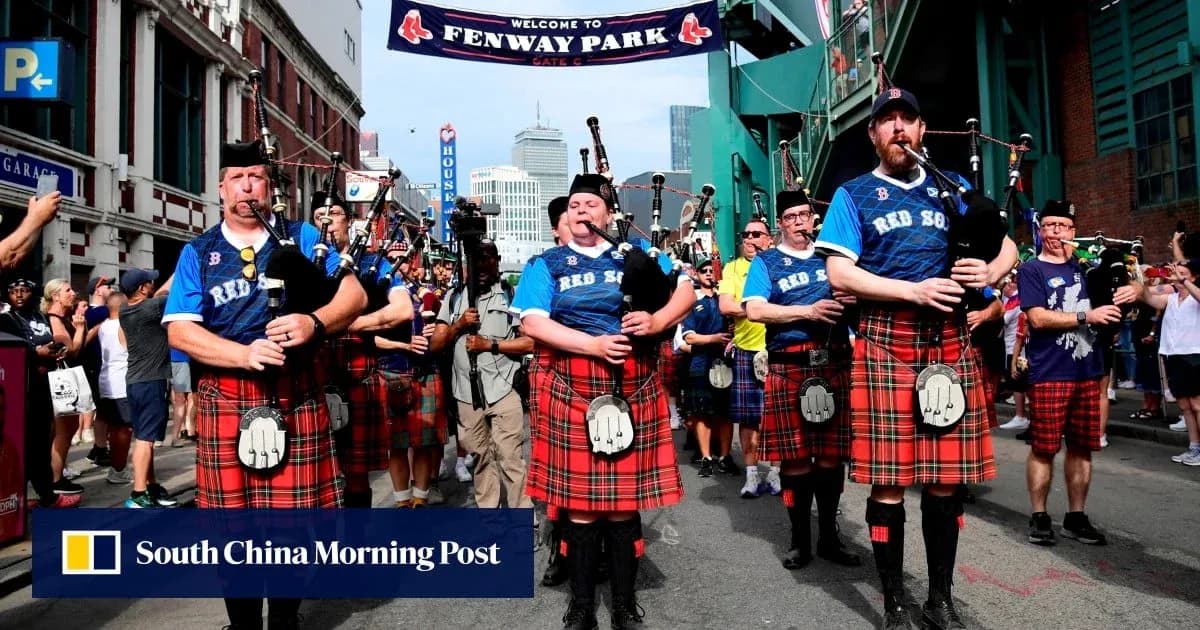 Bagpipers in kilts marching near Fenway Park