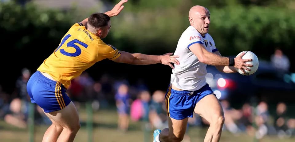 Player running with the ball, opponent reaching to tackle