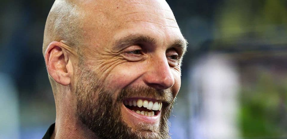 Coach smiling during press interview outdoors