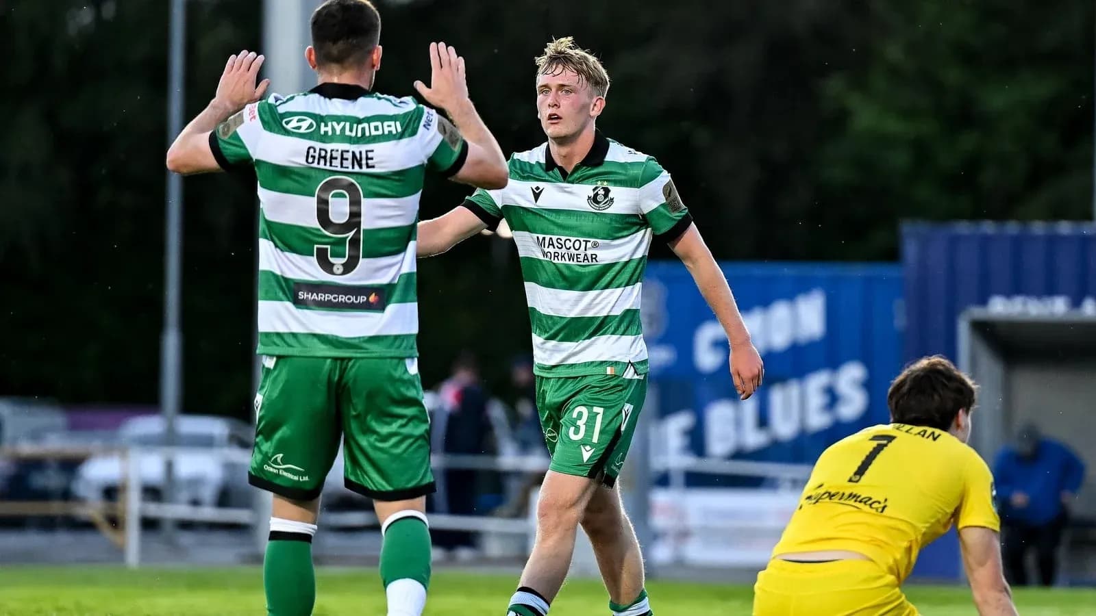 Two players celebrating a goal on the field Two players celebrating a goal on the field