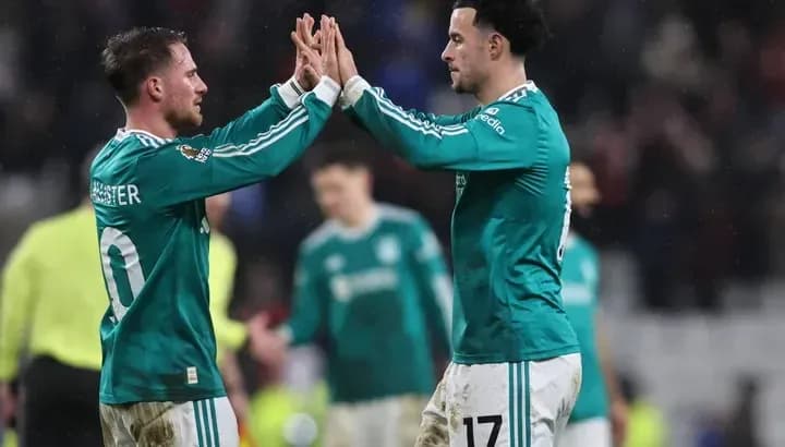 Two players celebrating with a high-five on field Two players celebrating with a high-five on field