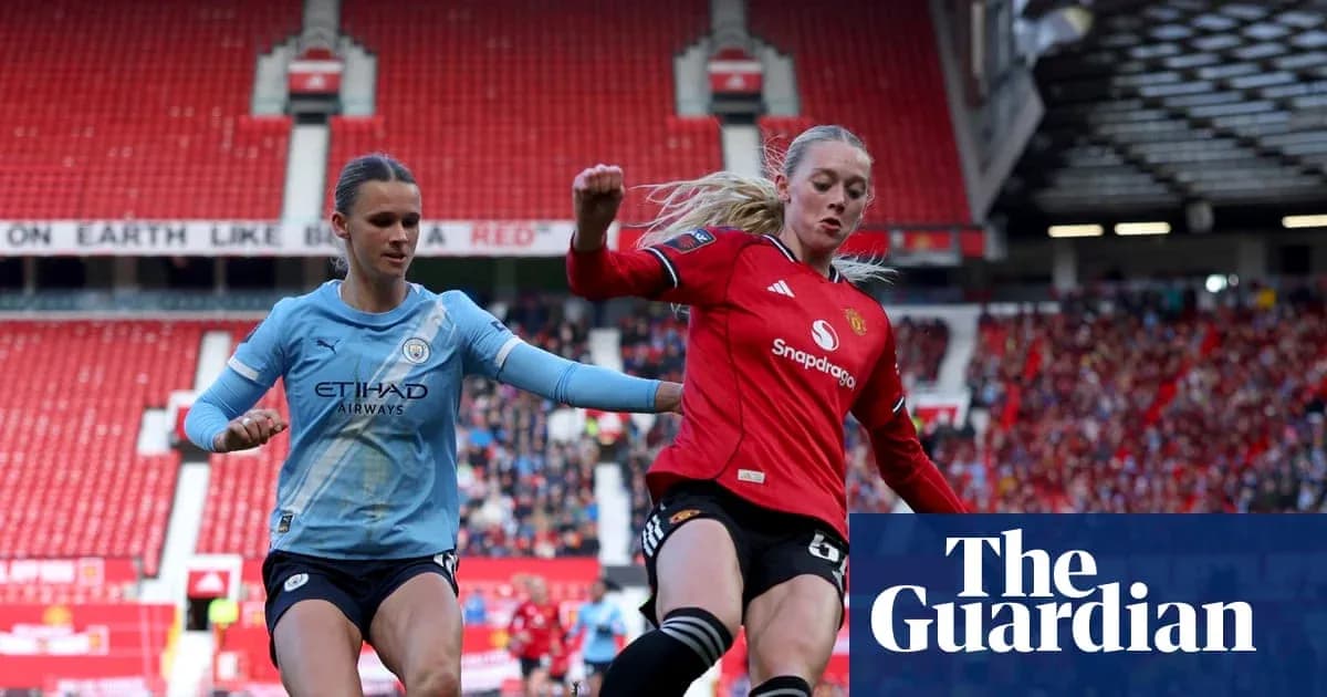 Players from Manchester City and Manchester United competing for the ball Players from Manchester City and Manchester United competing for the ball