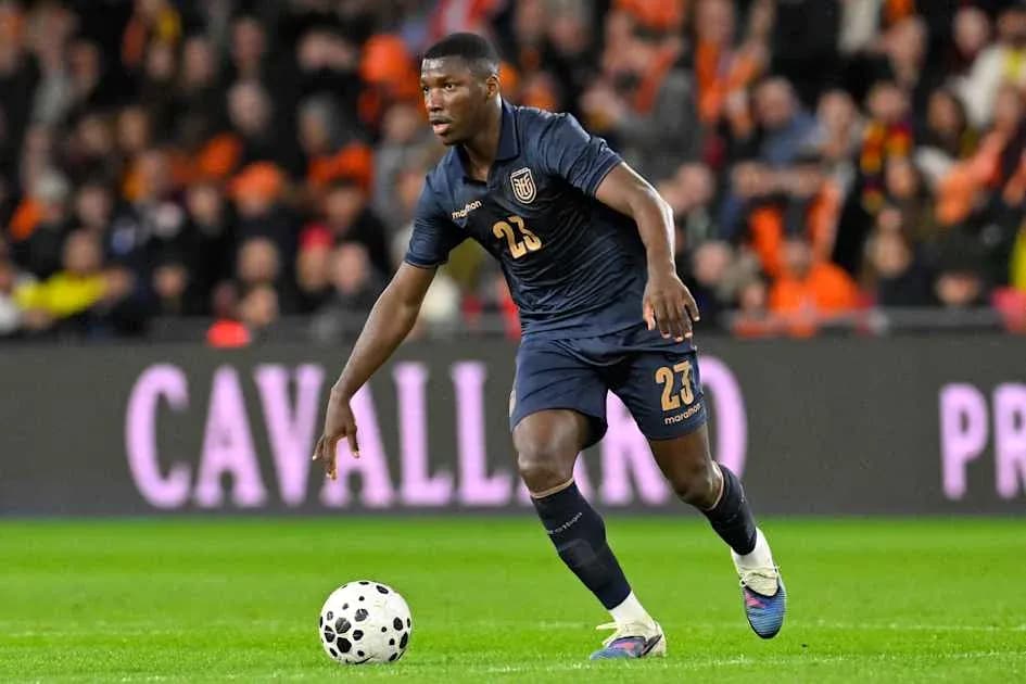 Player in dark jersey dribbling the ball on field Player in dark jersey dribbling the ball on field