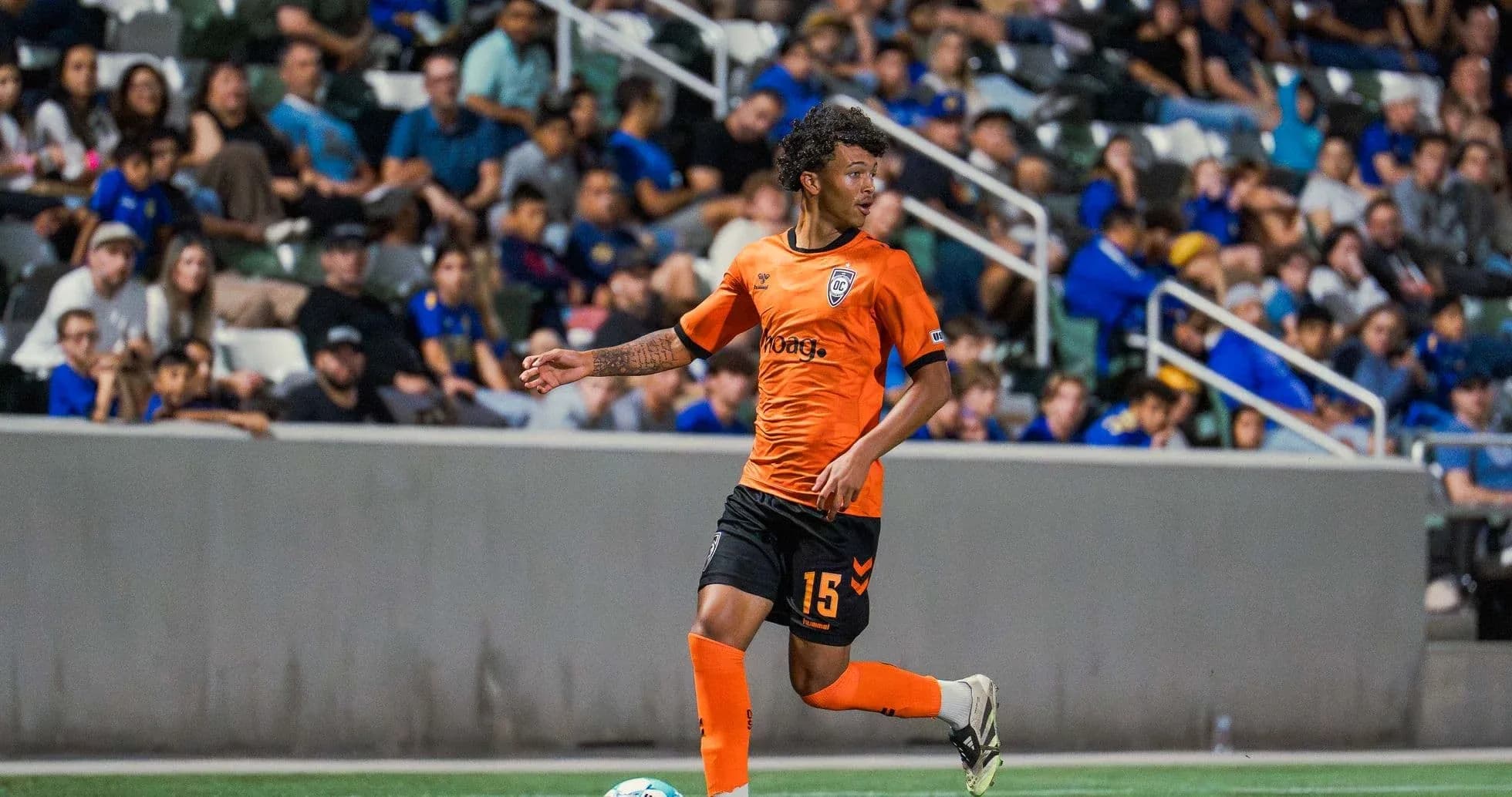 Player in orange jersey during USL League One match Player in orange jersey during USL League One match