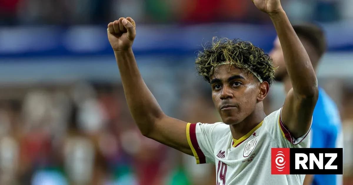 Player celebrating with raised arms on the field Player celebrating with raised arms on the field