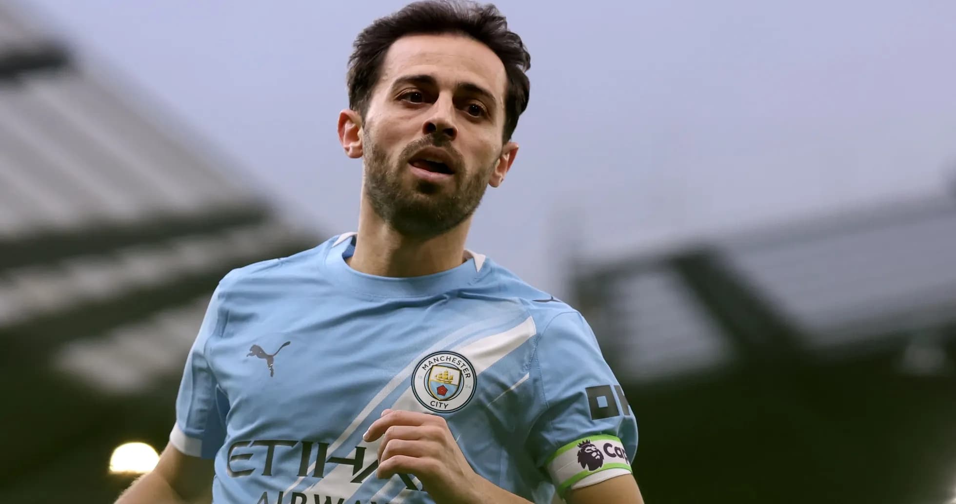 Player running in Manchester City kit during match Player running in Manchester City kit during match