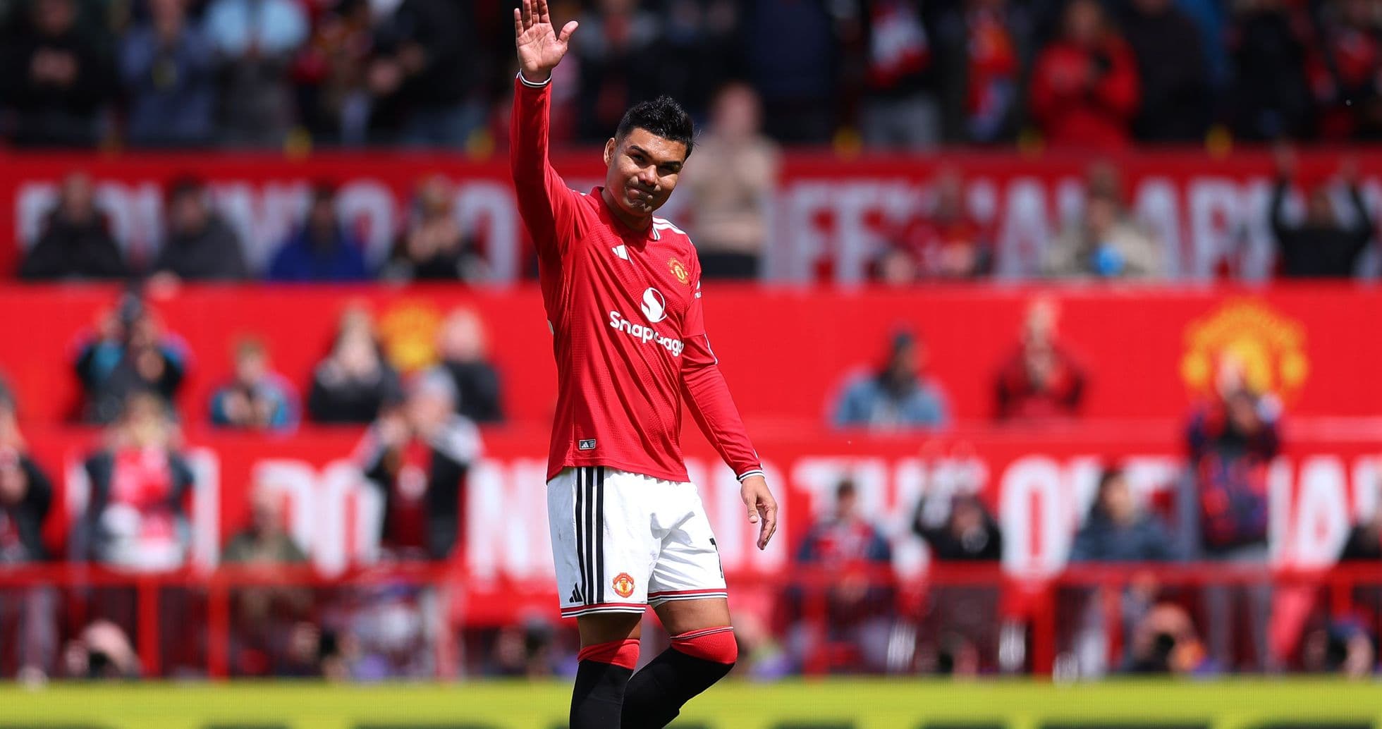 Player waving to fans in Manchester United jersey Player waving to fans in Manchester United jersey